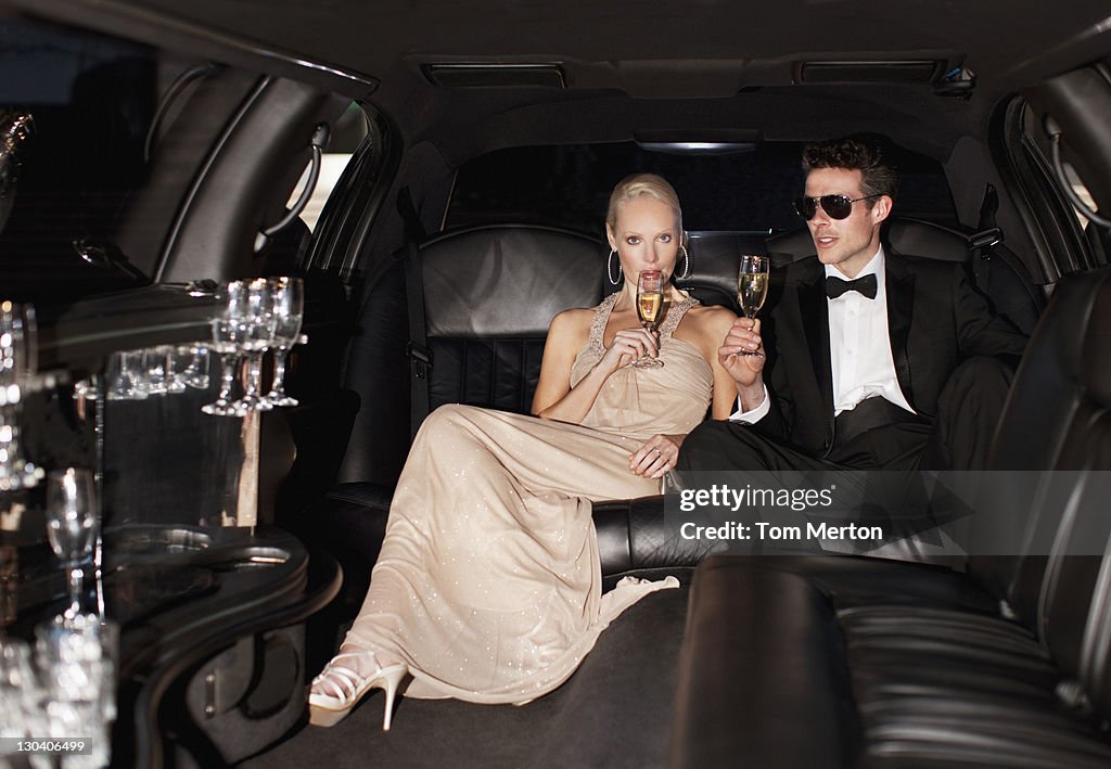 Couple drinking champagne in limo