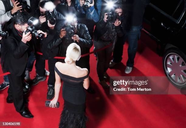 celebrity posing for paparazzi on red carpet - skådespelare bildbanksfoton och bilder