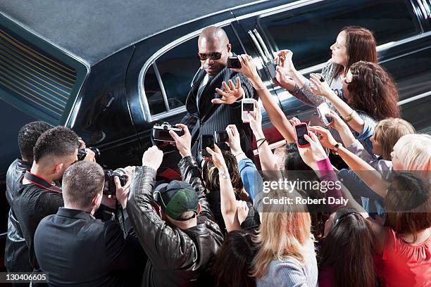 bodyguard protecting celebrity from paparazzi - paparazzi photographers stockfoto's en -beelden
