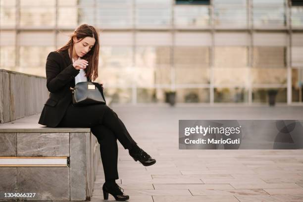 young woman searching inside her purse - purse contents stock pictures, royalty-free photos & images