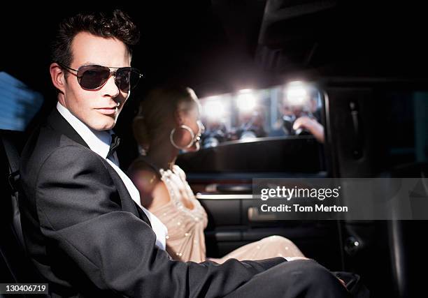 paparazzi taking pictures of celebrities in limo - paparazzi stock pictures, royalty-free photos & images