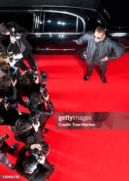 bodyguard protecting limo from paparazzi - red carpet paparazzi stock pictures, royalty-free photos & images