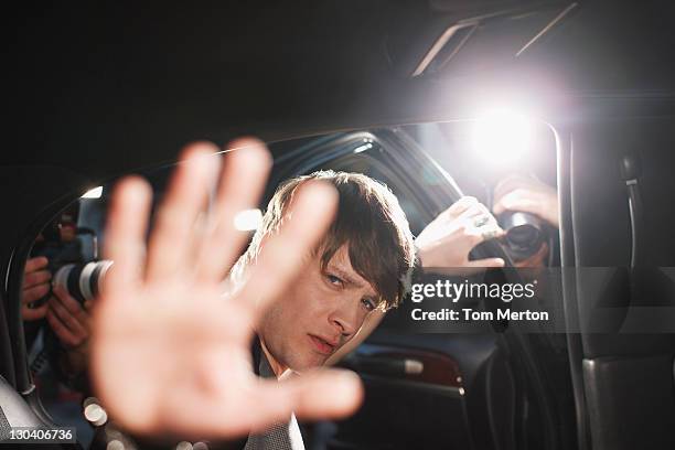 celebrity blocking photo in backseat of limo - paparazzi photographer stockfoto's en -beelden