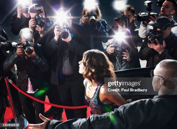 celebrity emerging from car towards paparazzi - camera flash stock pictures, royalty-free photos & images
