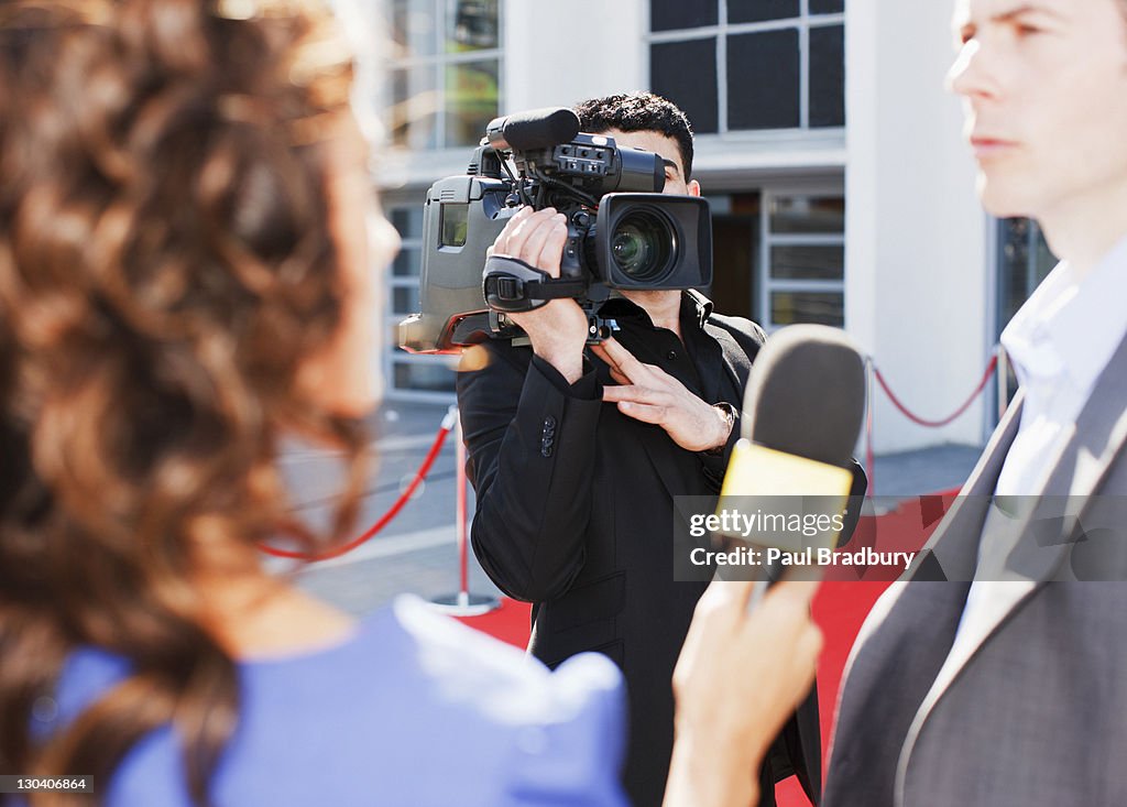 Cameraman taping celebrity on red carpet
