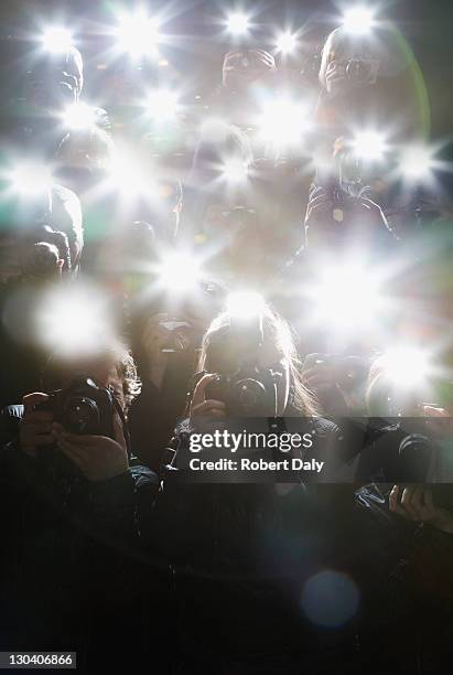 paparazzi taking pictures with flash - celebrity stockfoto's en -beelden