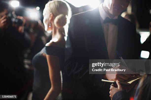 celebrity signing autographs on red carpet - formalwear stock pictures, royalty-free photos & images