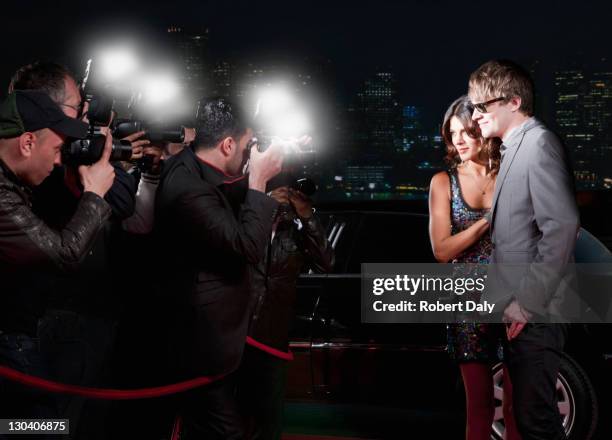 celebrities posing for paparazzi on red carpet - red carpet paparazzi stock pictures, royalty-free photos & images