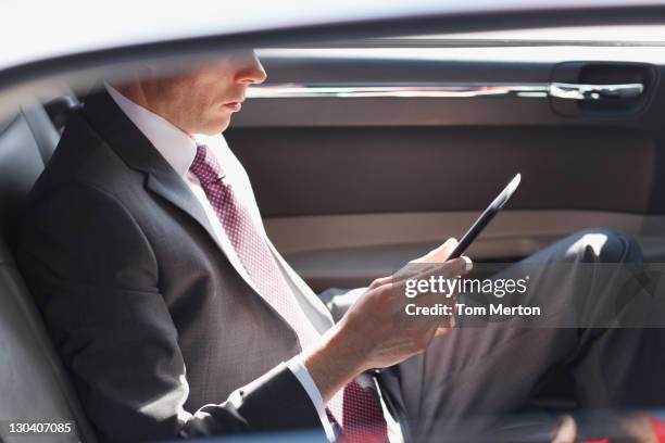 politician reading in backseat of car - luxury car 個照片及圖片檔