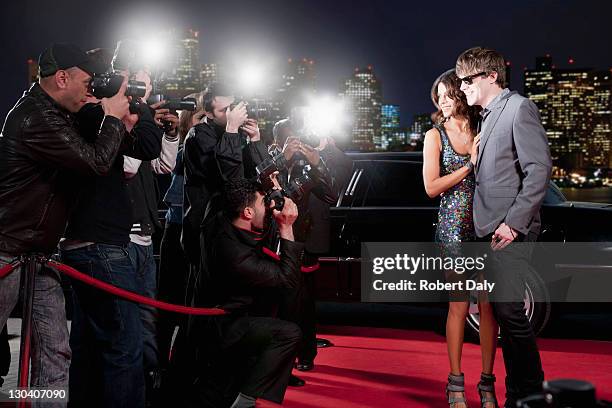 celebrities posing for paparazzi on red carpet - paparazzi stock pictures, royalty-free photos & images