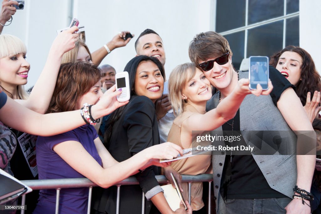 Celebrity taking pictures with fans