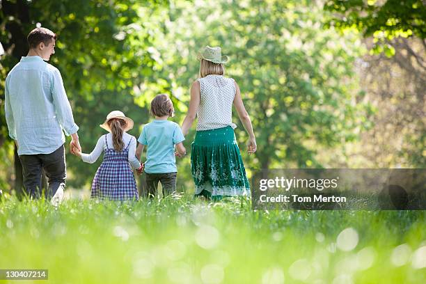 family walking in field of flowers - family with two children british stock pictures, royalty-free photos & images