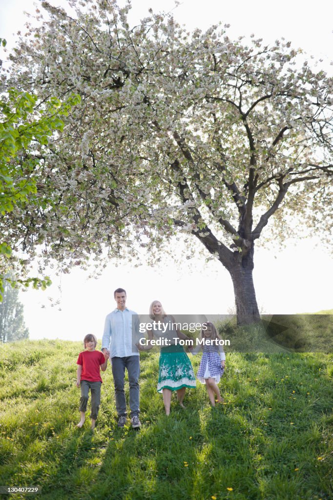 Family walking together under tree in park