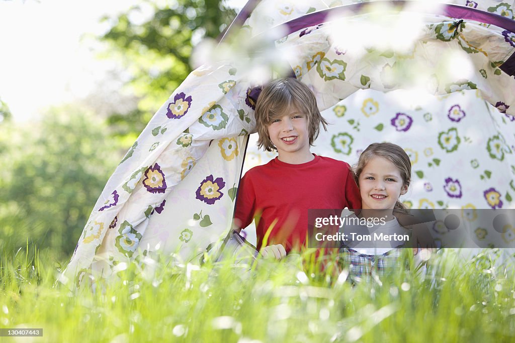 Children playing in tent in park