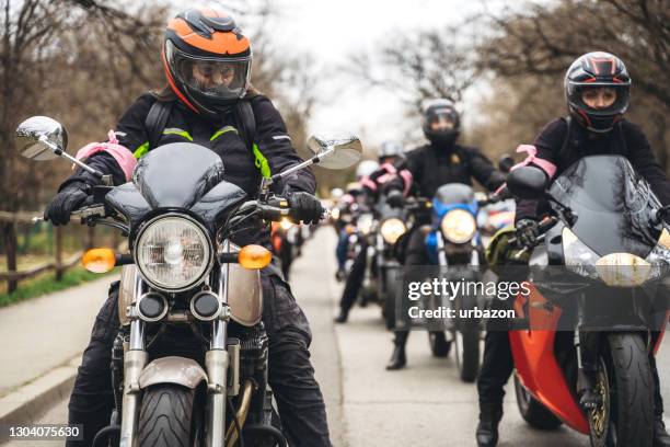 female bikers on road - motorcycle group stock pictures, royalty-free photos & images