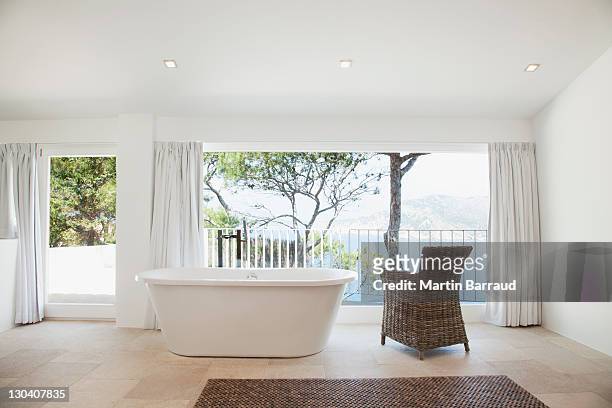 upright bathtub in modern bathroom - muted color stock pictures, royalty-free photos & images
