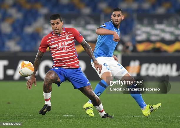 Kenedy of Granada CF is challenged by Faouzi Ghoulam of SSC Napoli during the UEFA Europa League Round of 32 match between SSC Napoli and Granada CF...