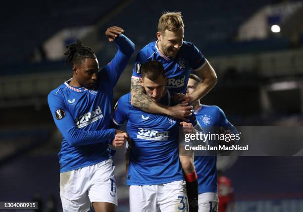 Borna Barisic of Rangers celebrates after scoring their team's fourth goal from the penalty spot with Ryan Kent of Rangers and Scott Arfield of...