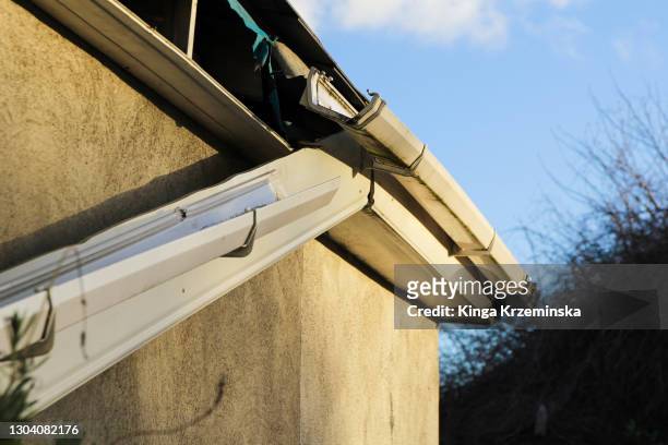 broken roof gutter - roof gutter stock pictures, royalty-free photos & images