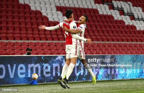 Ajax player David Neres celebrates with team mate Edson Alvarez after scoring the second Ajax goal during the UEFA Europa League Round of 32 match...