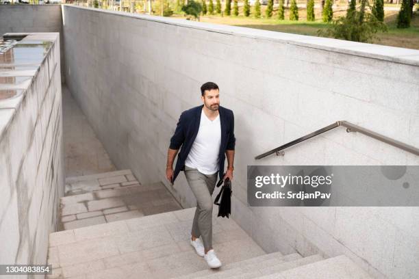 modern businessman moving upstairs - business casual outside stock pictures, royalty-free photos & images