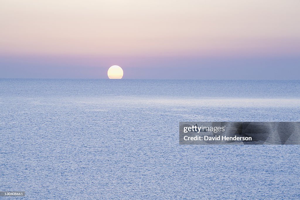 Boat on water at sunset