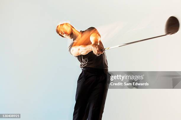 blurred view of golf player swinging club - golf swing on white stock pictures, royalty-free photos & images