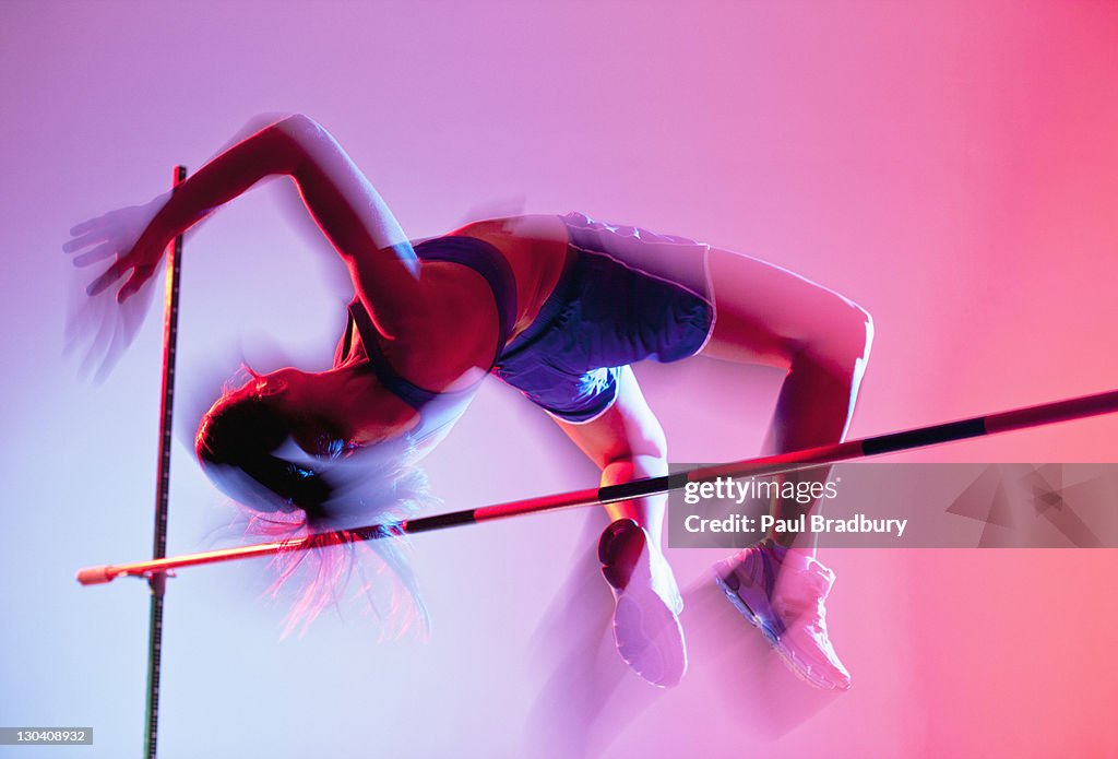 Athlete curling over high jump