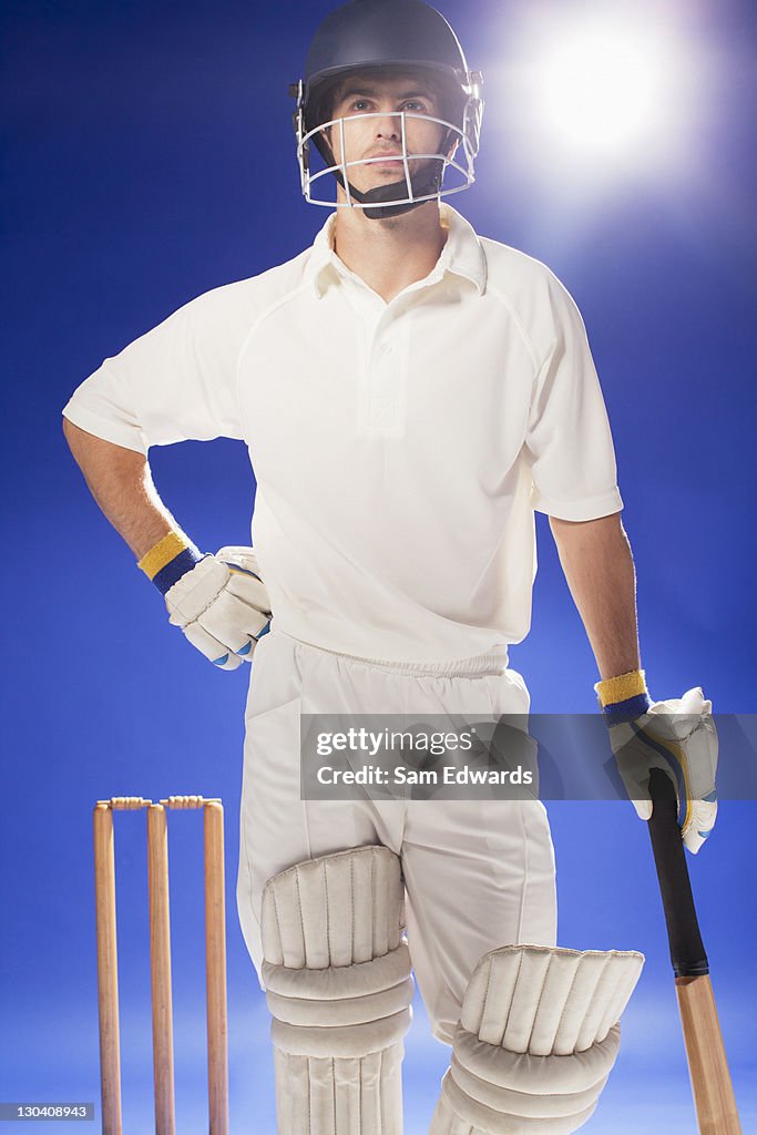 Cricket player standing with bat