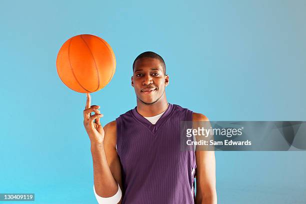 basketball player balancing ball on one finger - basketball uniform 個照片及圖片檔