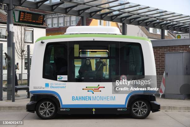 An almost fully autonomous electric mini bus, without a driver, drives through the streets on the two-kilometer route between the bus station and the...