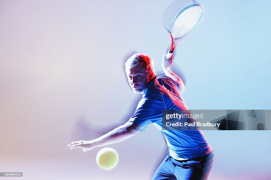 Tennis player swinging racket