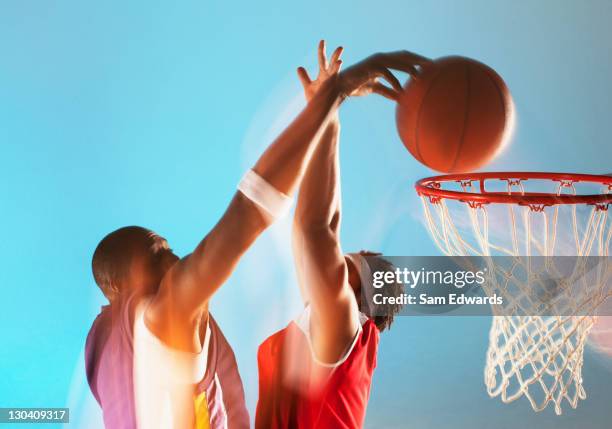 blurred view of basketball player dunking - basketball blocking shot stock pictures, royalty-free photos & images