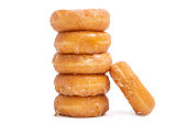 donuts with icing sugar stacked on white background