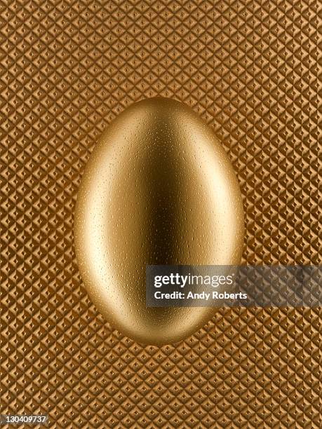 close up of golden egg - golden egg stock pictures, royalty-free photos & images