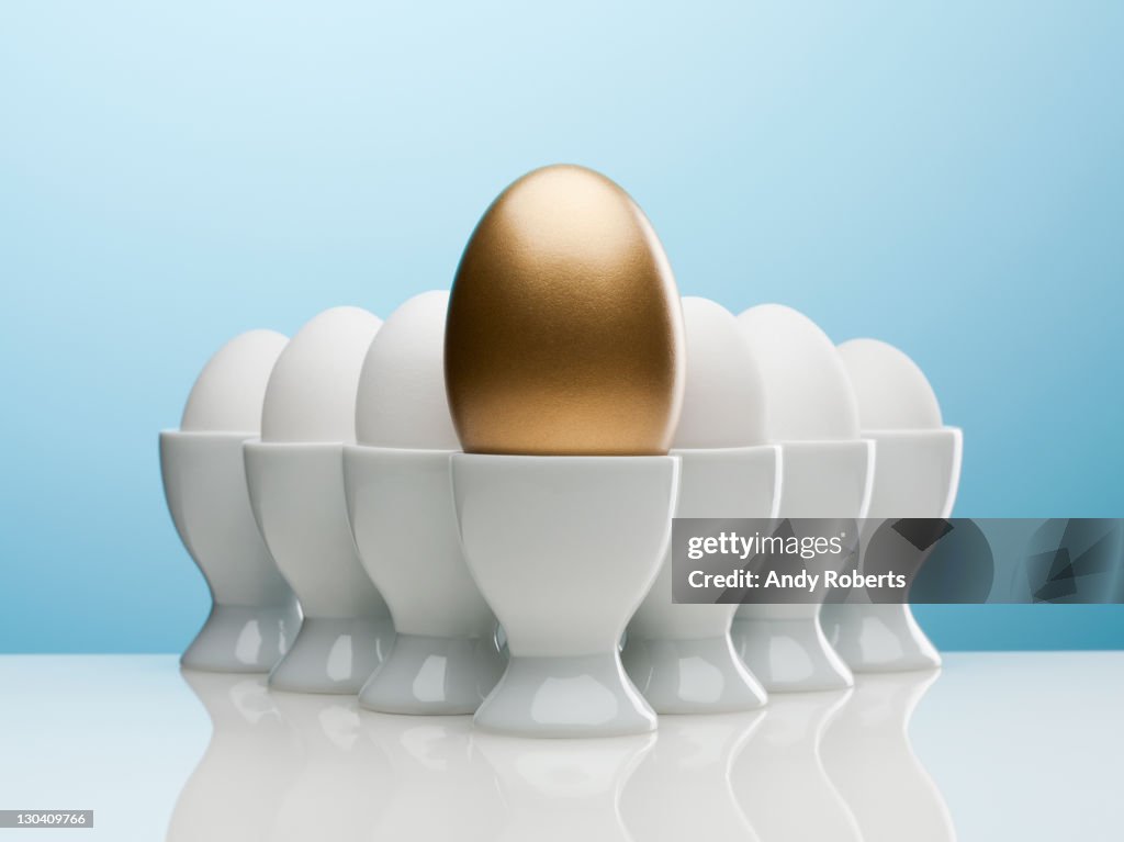 Golden egg in egg cup