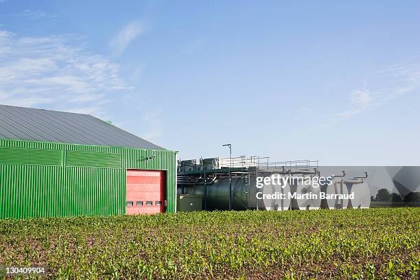 tanks outside warehouse in rural landscape - agrarisch gebouw stockfoto's en -beelden