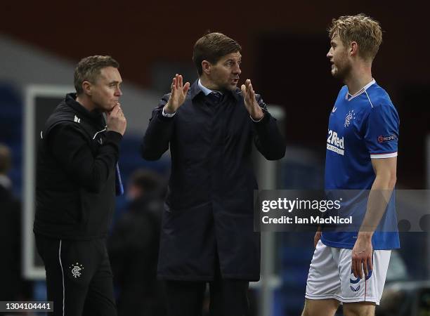 Rangers Manager Steven Gerrard talks with Filip Helander during the UEFA Europa League Round of 32 match between Rangers FC and Royal Antwerp FC at...