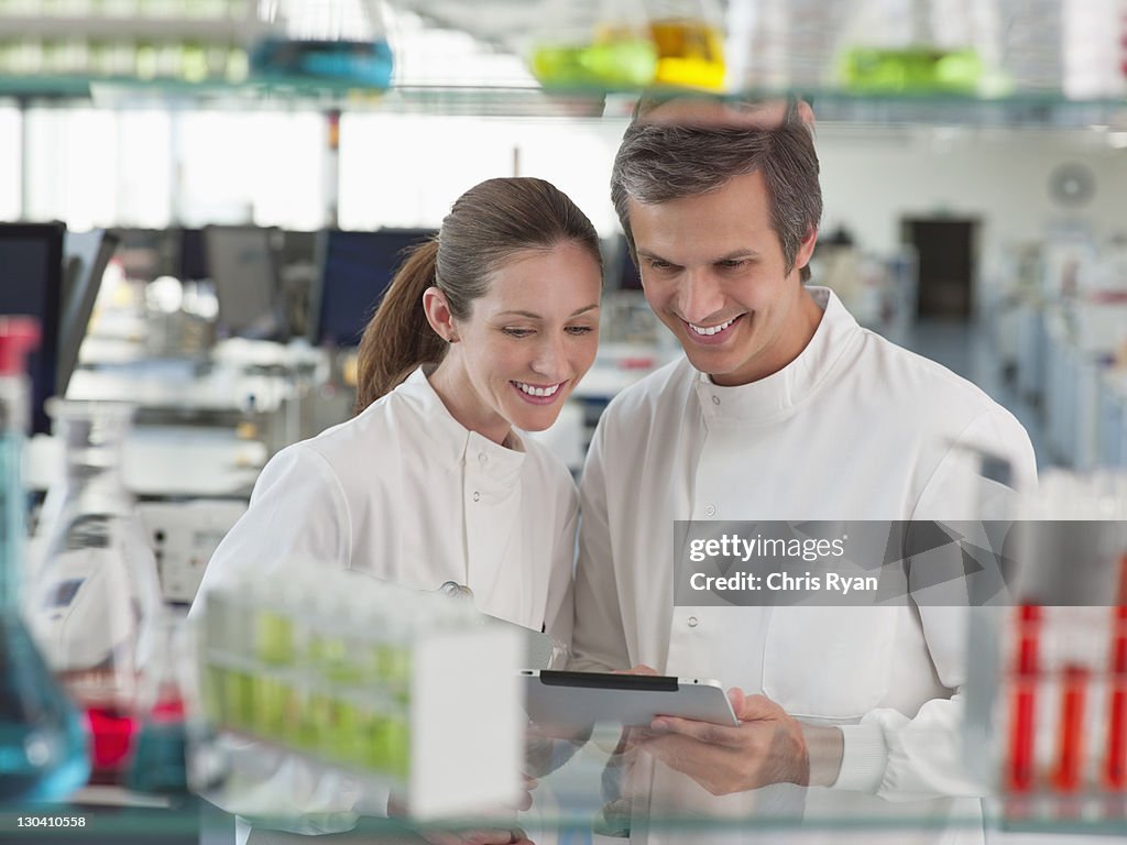Scientists reading clipboard in lab