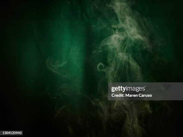 steam against textured green background - green potion stock pictures, royalty-free photos & images