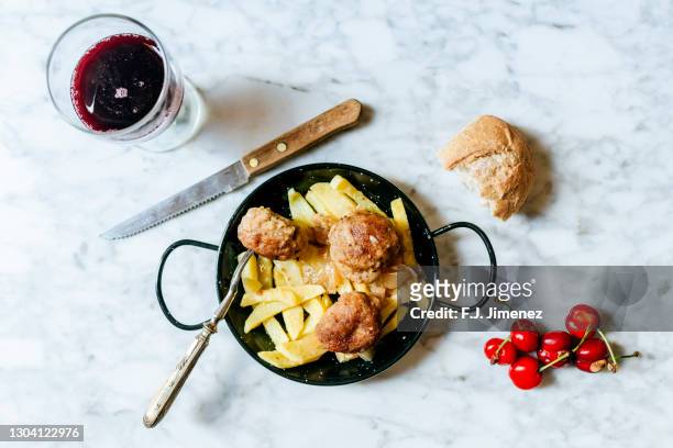 table with homemade meatballs, wine and cherries - covered food with wine stock pictures, royalty-free photos & images