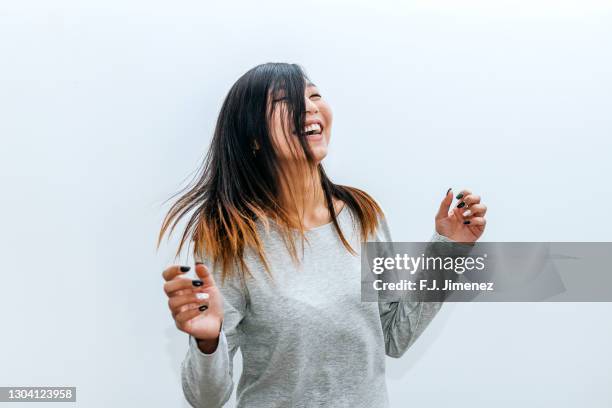 portrait of woman dancing on white background - woman portrait plain background stock pictures, royalty-free photos & images
