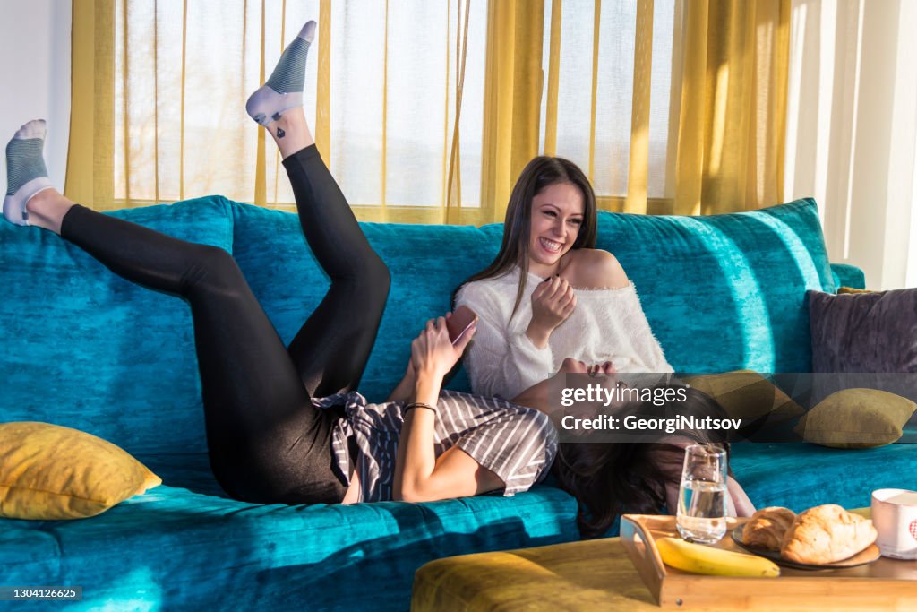 Two young female friends at their home over the weekend