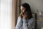 Sad compassionate young lady support friend in phone talk