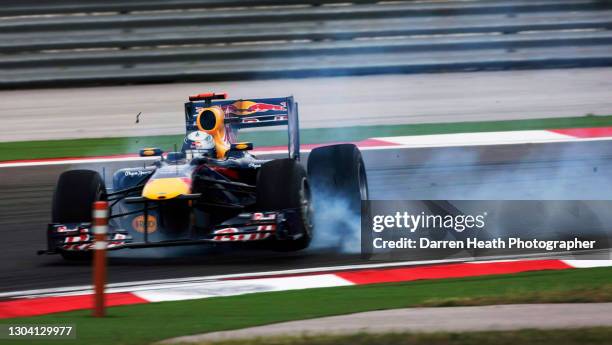 German Red Bull Racing Formula One driver Sebastian Vettel driving his RB6 racing car skidding sideways after crashing with his Red Bull Racing...