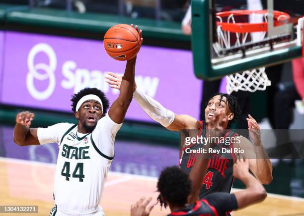 Gabe Brown of the Michigan State Spartans grabs a rebound against Justice Sueing of the Ohio State Buckeyes in the second half at Breslin Center on...