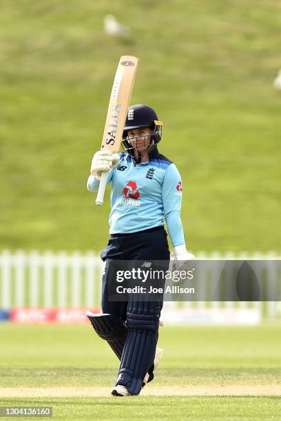 Tamsin Beaumont of England raises her bat after scoring 50 runs during game two of the One Day International series between New Zealand and England...