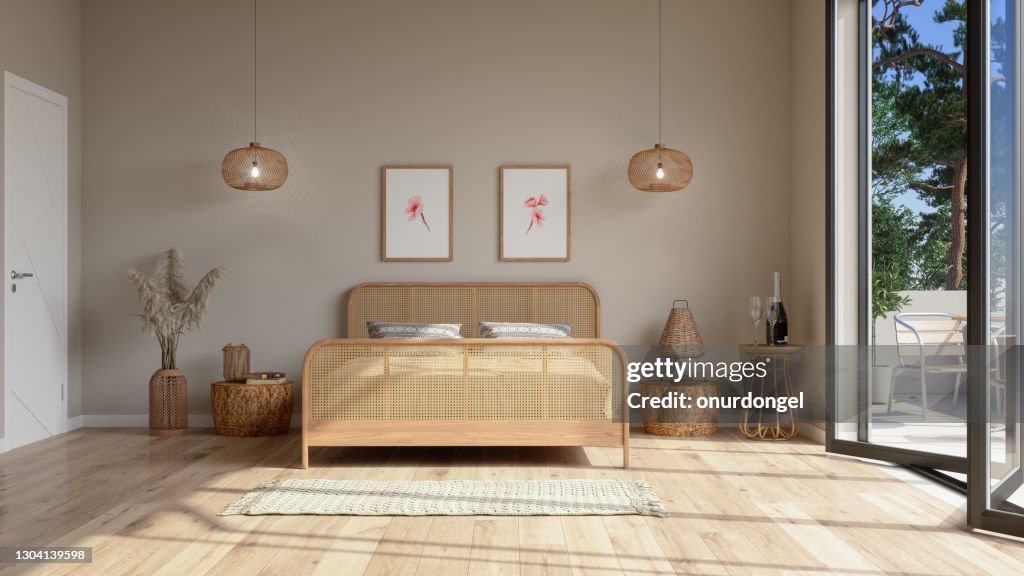 Bedroom Interior In Beige Color With Wicker Bed Furniture, Pendant Lights, Balcony And Posters On The Wall.