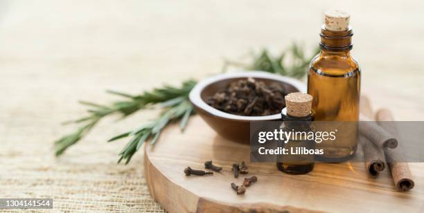 essential oils with rosemary, cloves & cinnamon. - herbs and spices stock pictures, royalty-free photos & images