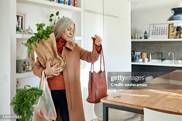 mid 60s caucasian woman arriving home with groceries - senior women shopping stock pictures, royalty-free photos & images